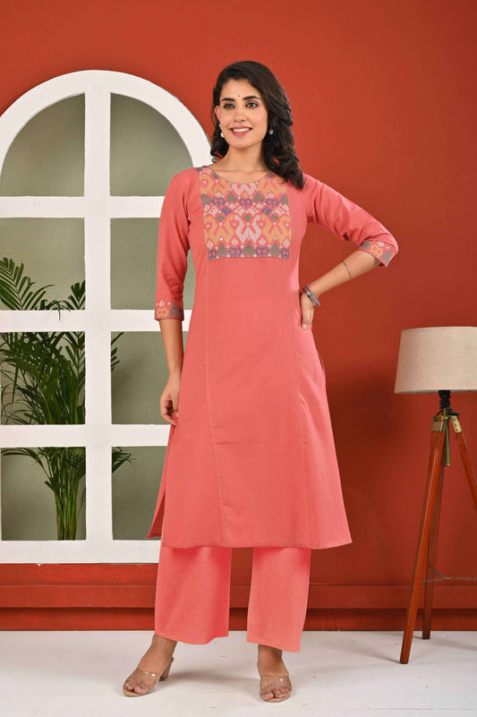 Women's ethnic kurta pant sets in coral with intricate embroidered neckline and three-quarter sleeves