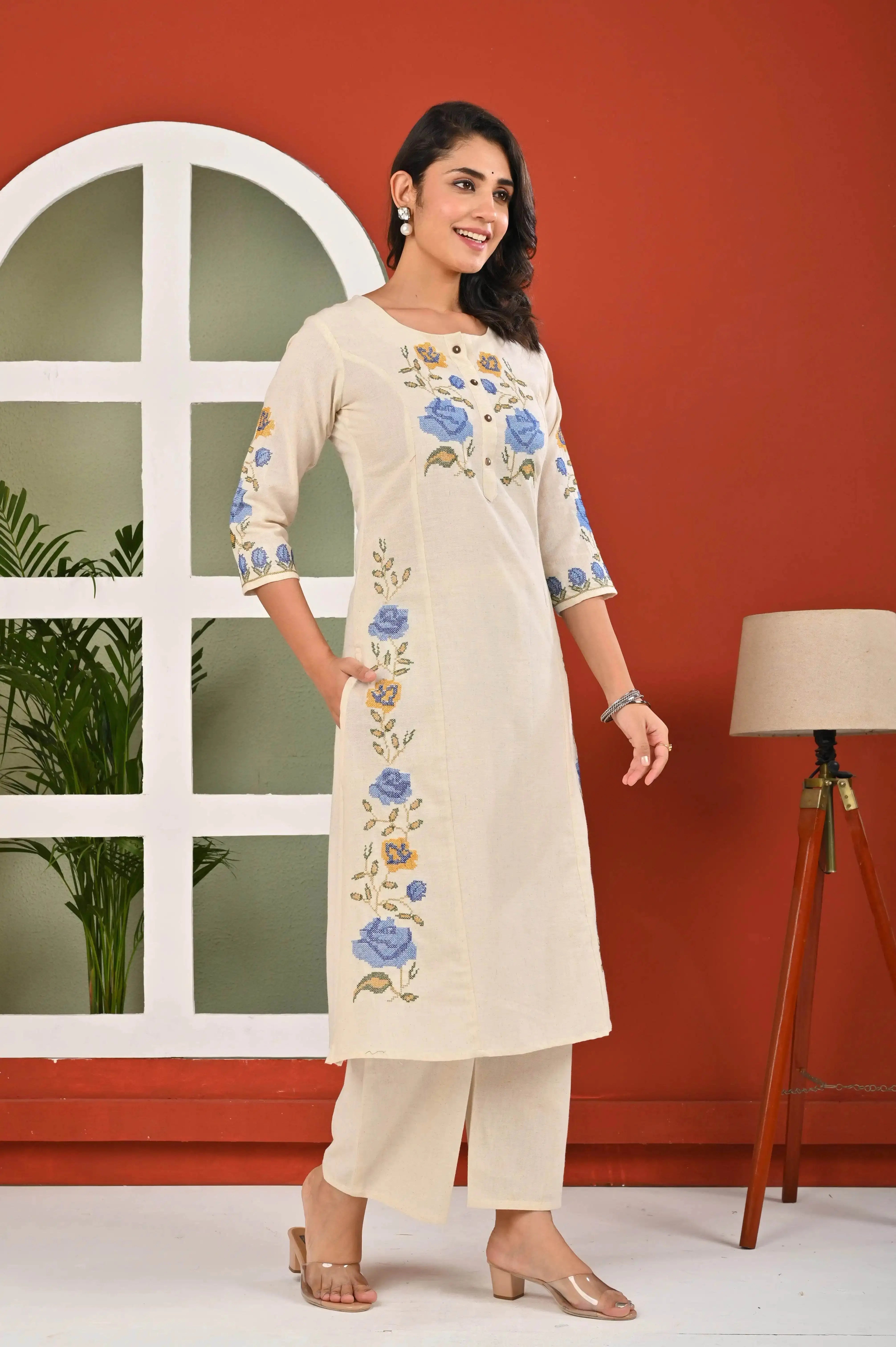 Elegant floral kurti for women in cream with blue flower embroidery and 3 quarter sleeves