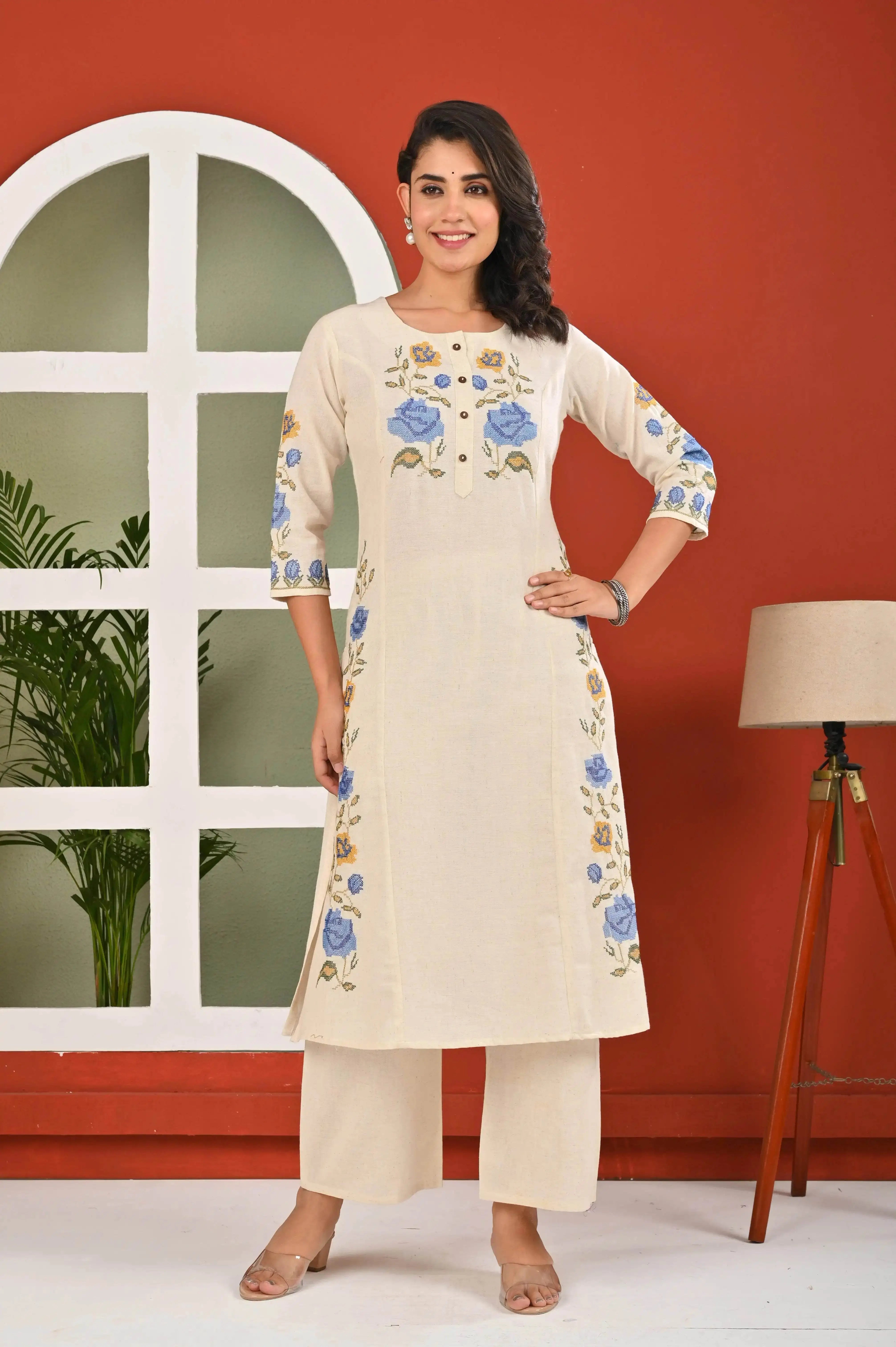 Elegant floral kurti for women in cream with blue floral embroidery and three-quarter sleeves