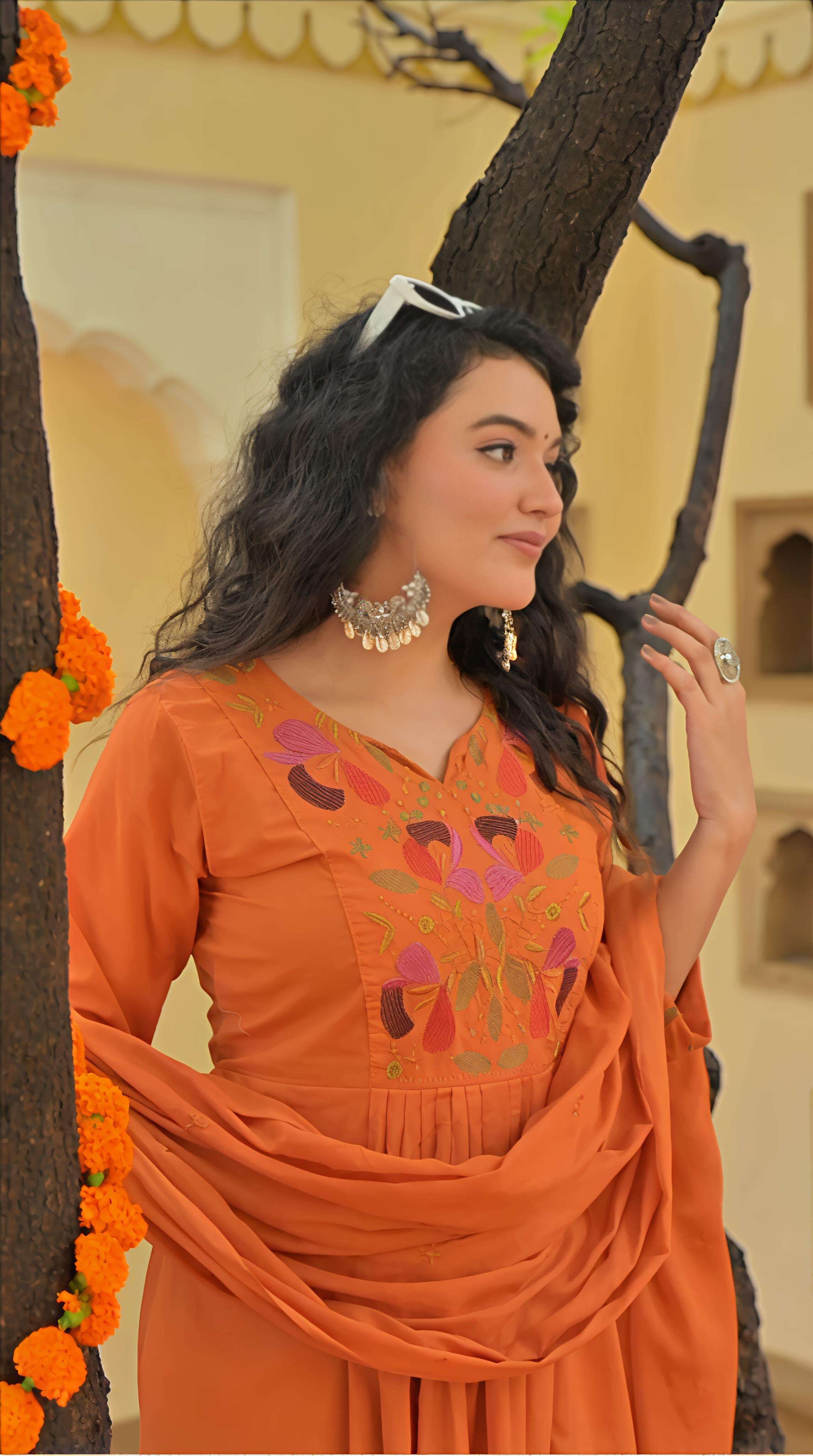 Belveera embroidered kurta pant dupatta set in orange with colorful floral embroidery and draped dupatta