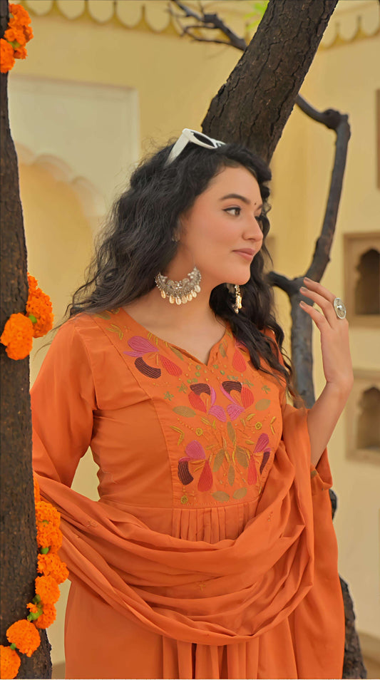 Belveera embroidered kurta pant dupatta set in orange with colorful floral embroidery and draped dupatta