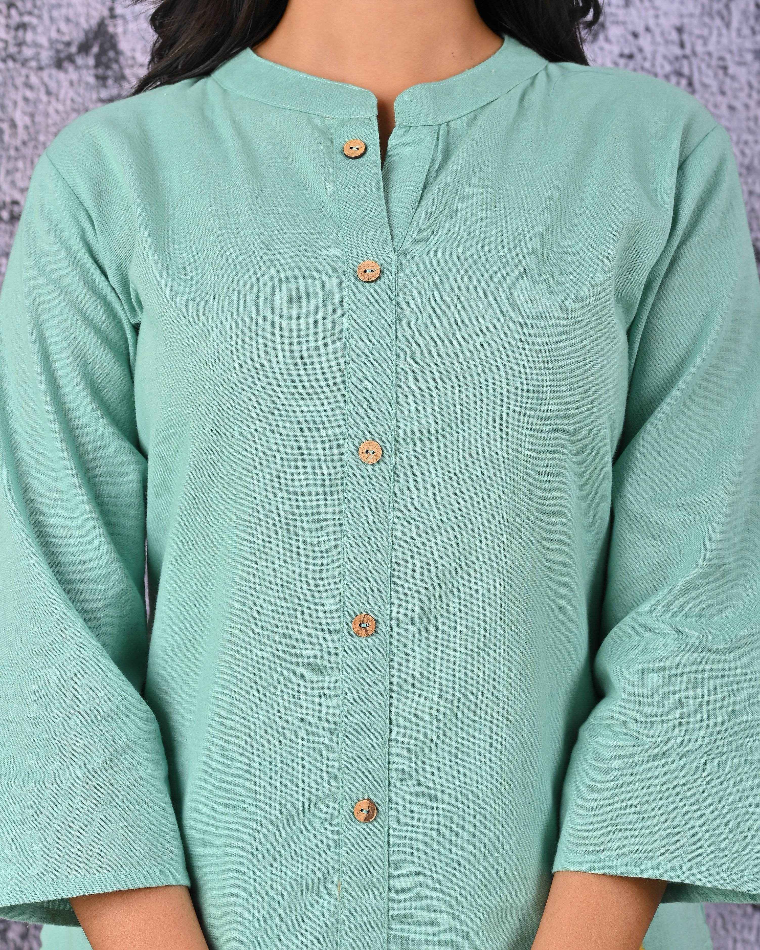 Elegant green cotton kurta set with button detailing and three-quarter sleeves for a stylish look