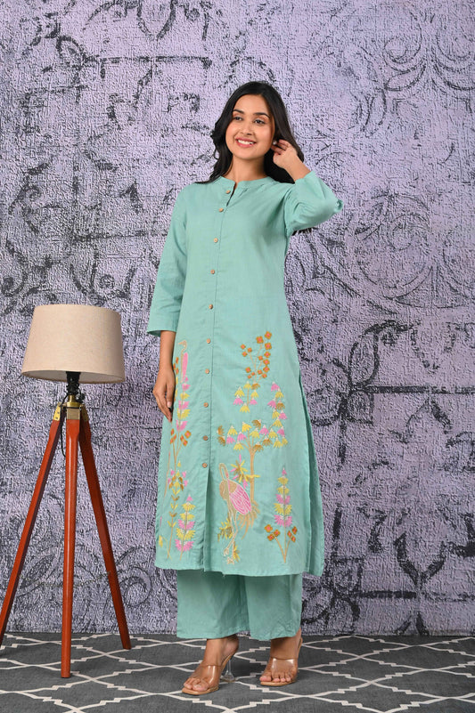 Green cotton kurta set with colorful floral embroidery and matching palazzo pants for a stylish look