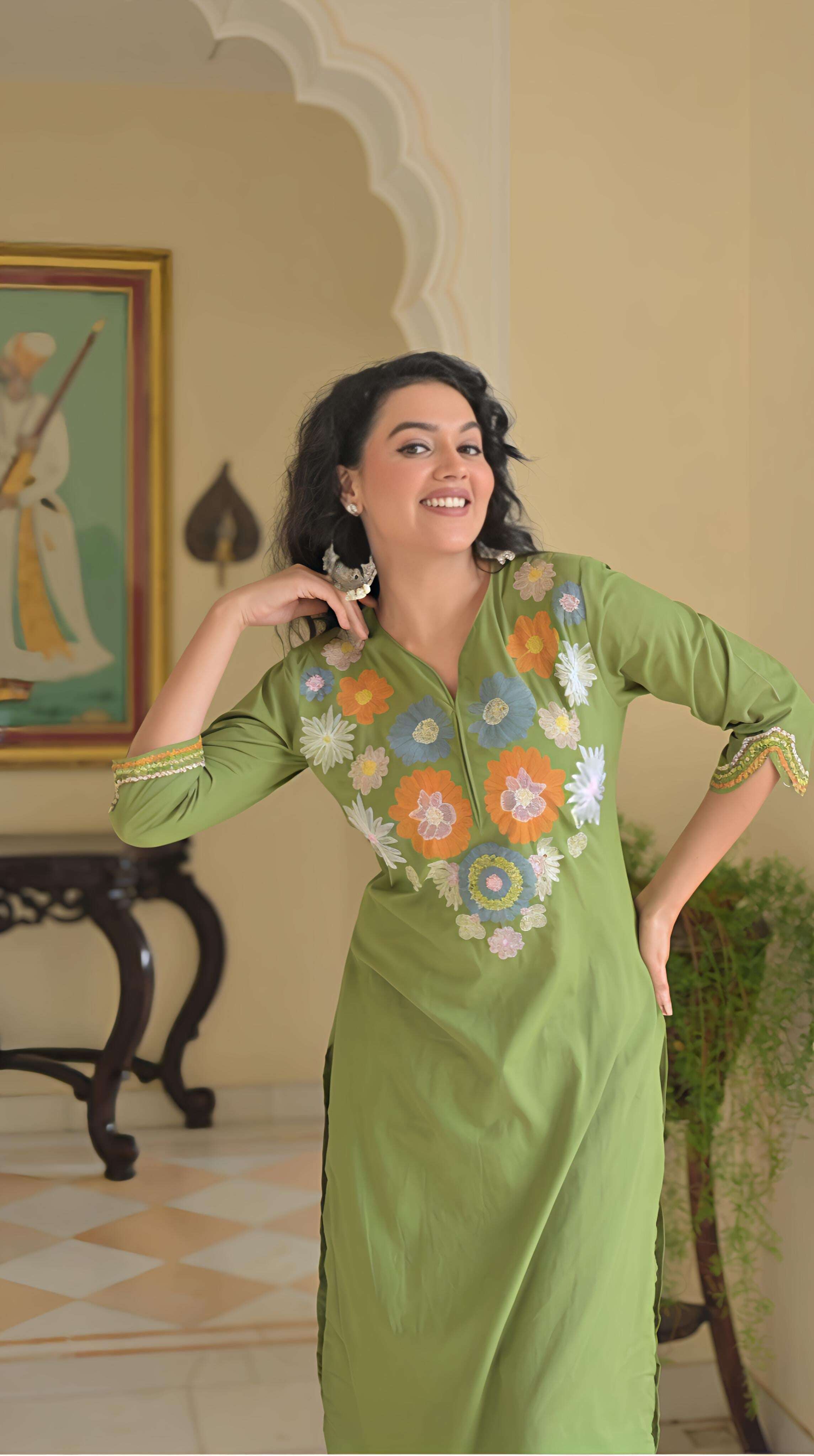 Elegant green cotton kurta set for women with floral embroidery and a stylish neckline