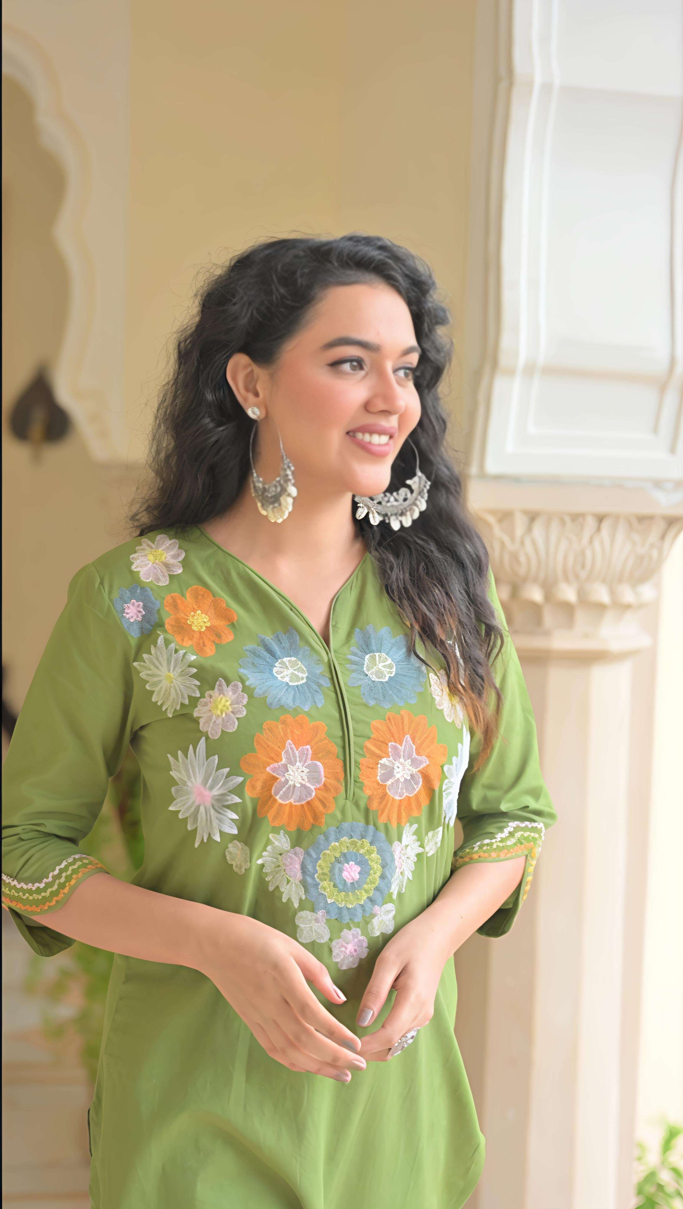 Elegant green cotton kurta set for women featuring beautiful floral embroidery and a relaxed fit