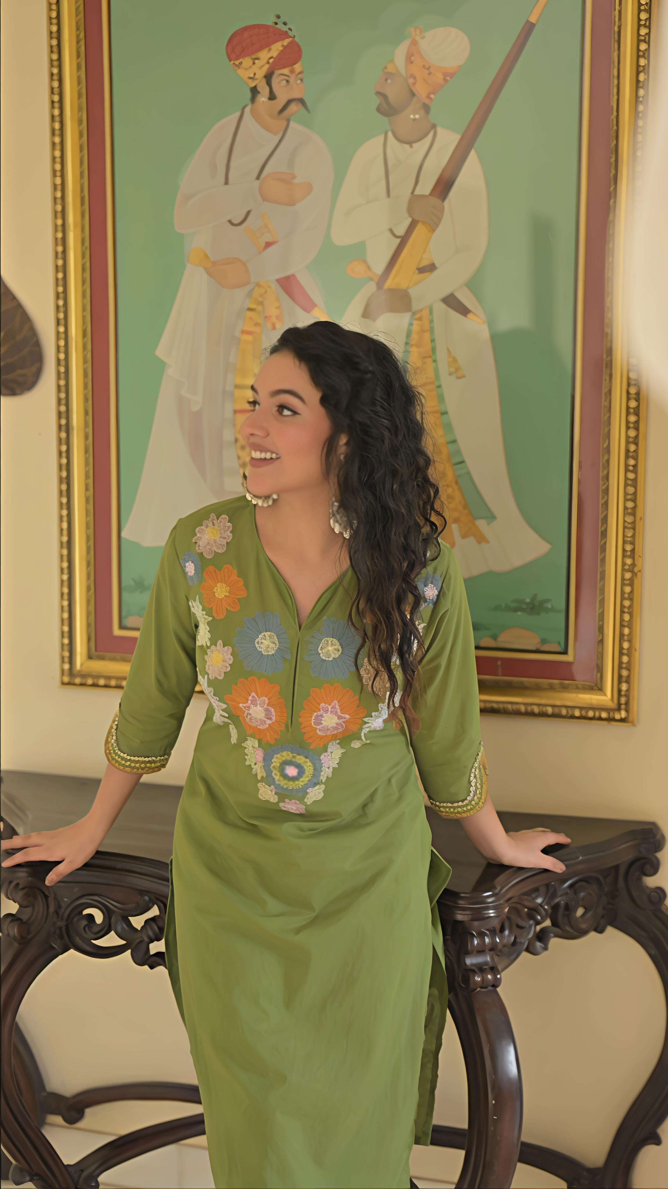 Charming green cotton kurta set for women with colorful embroidery details and comfortable fit