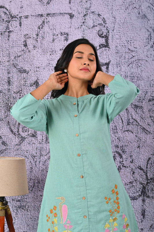 Elegant green cotton kurta set with vibrant embroidery for a stylish and comfortable look