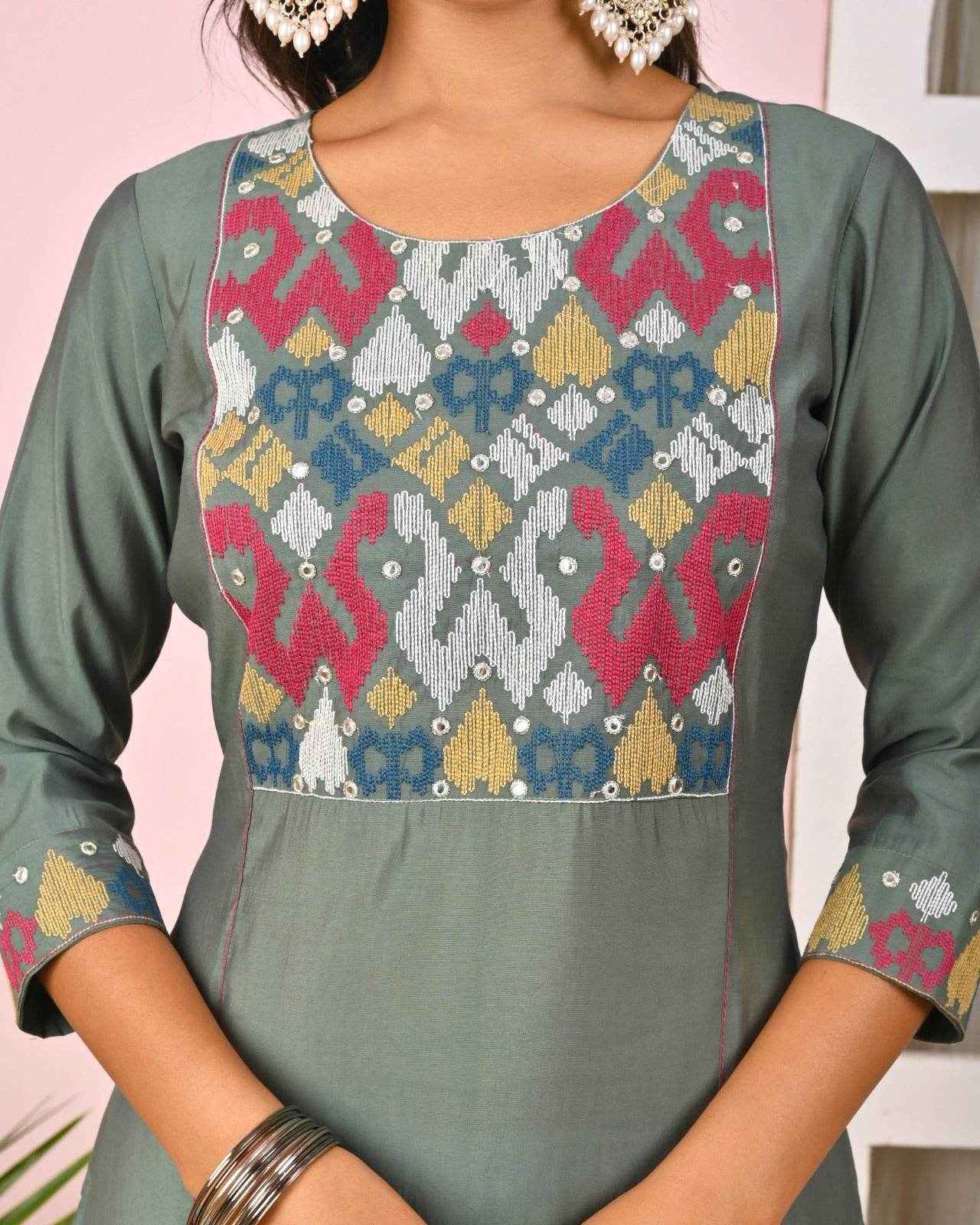 Green embroidered kurta for women featuring intricate multicolor patterns and three-quarter sleeves