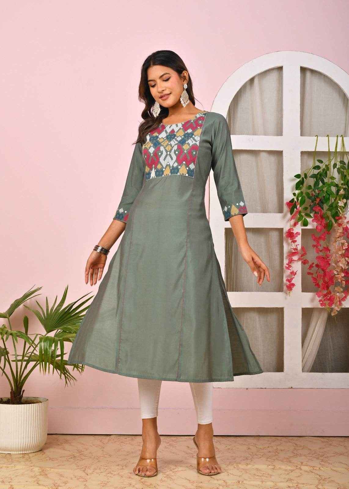 Elegant green embroidered kurta for women with colorful patterns on the bodice and three-quarter sleeves