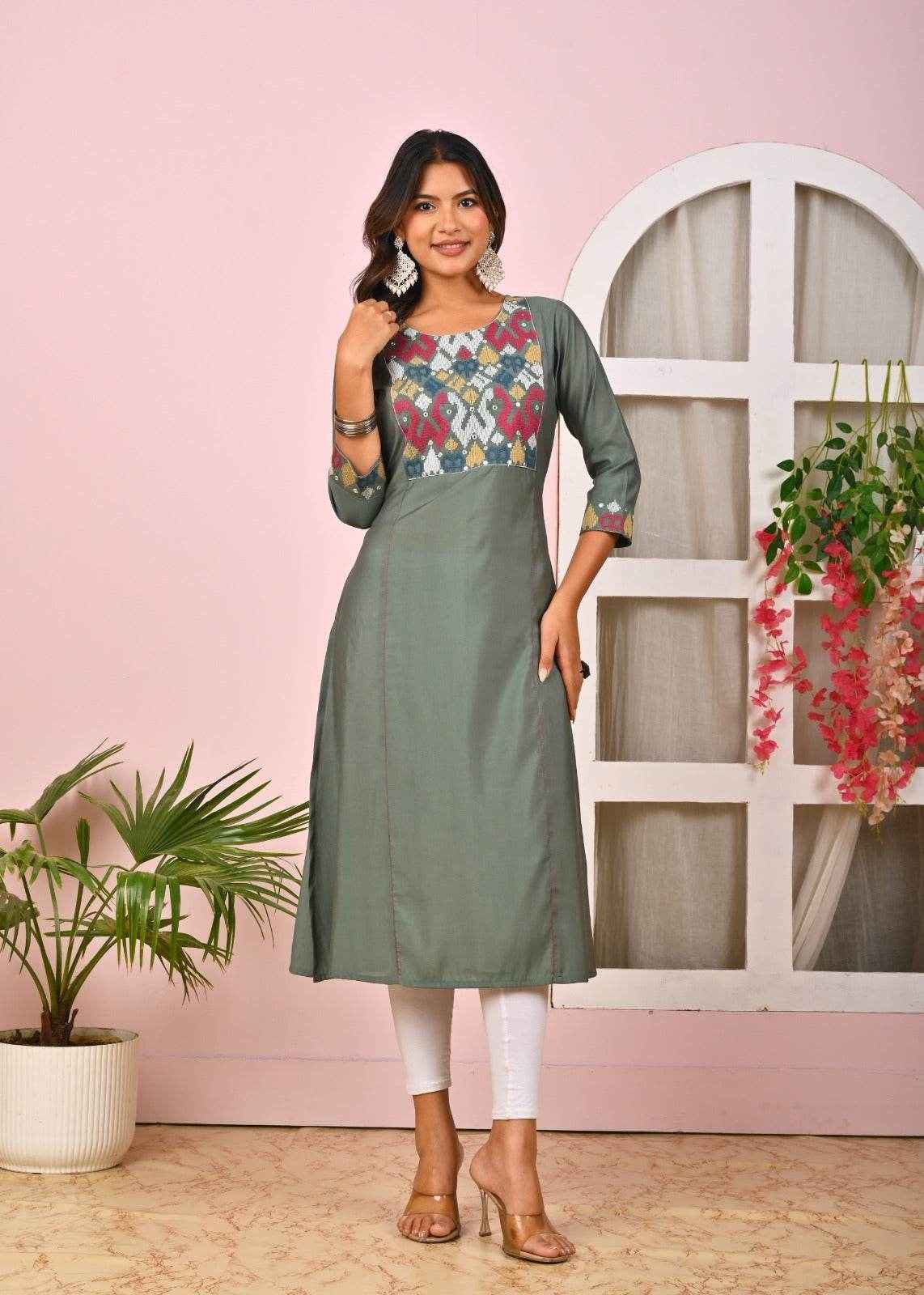 Stylish green embroidered kurta for women with colorful floral design and three-quarter sleeves