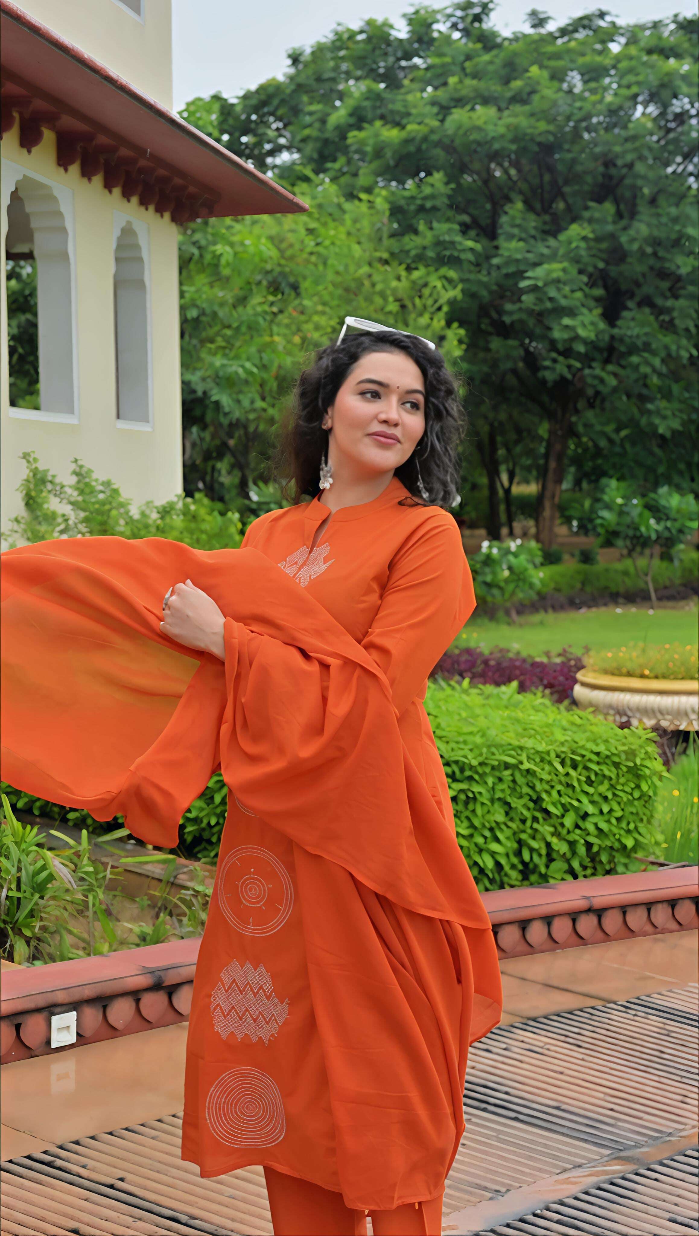 Elegant orange cotton kurta set with bell sleeves, perfect for festive occasions and casual wear