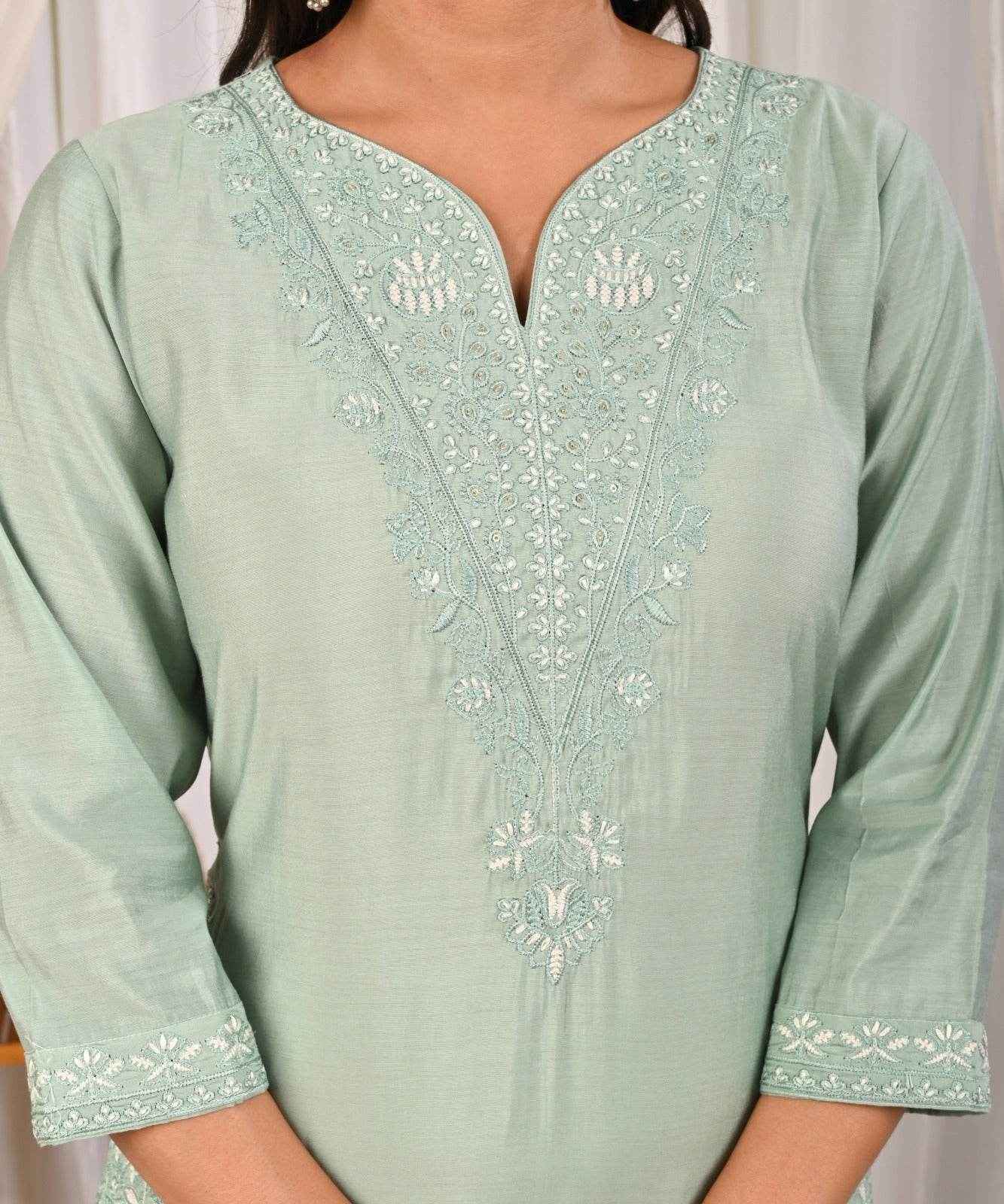 Pastel mint green silk kurta with intricate embroidery and a flattering neckline