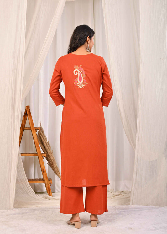 Back view of a woman wearing a rust floral embroidered kurta set with detailed embroidery