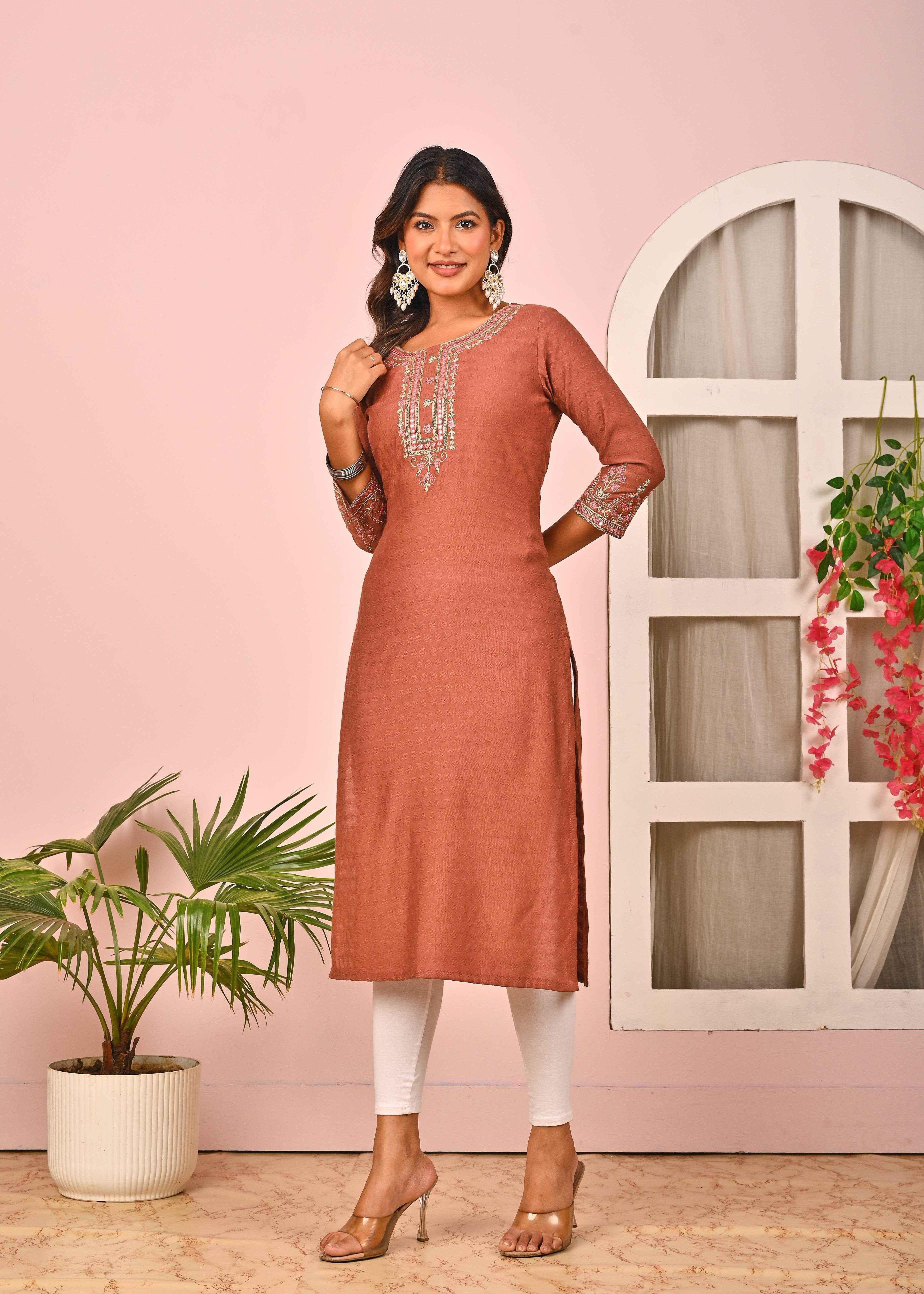 Elegant rust orange cotton kurta featuring intricate embroidery and a comfortable fit for casual wear