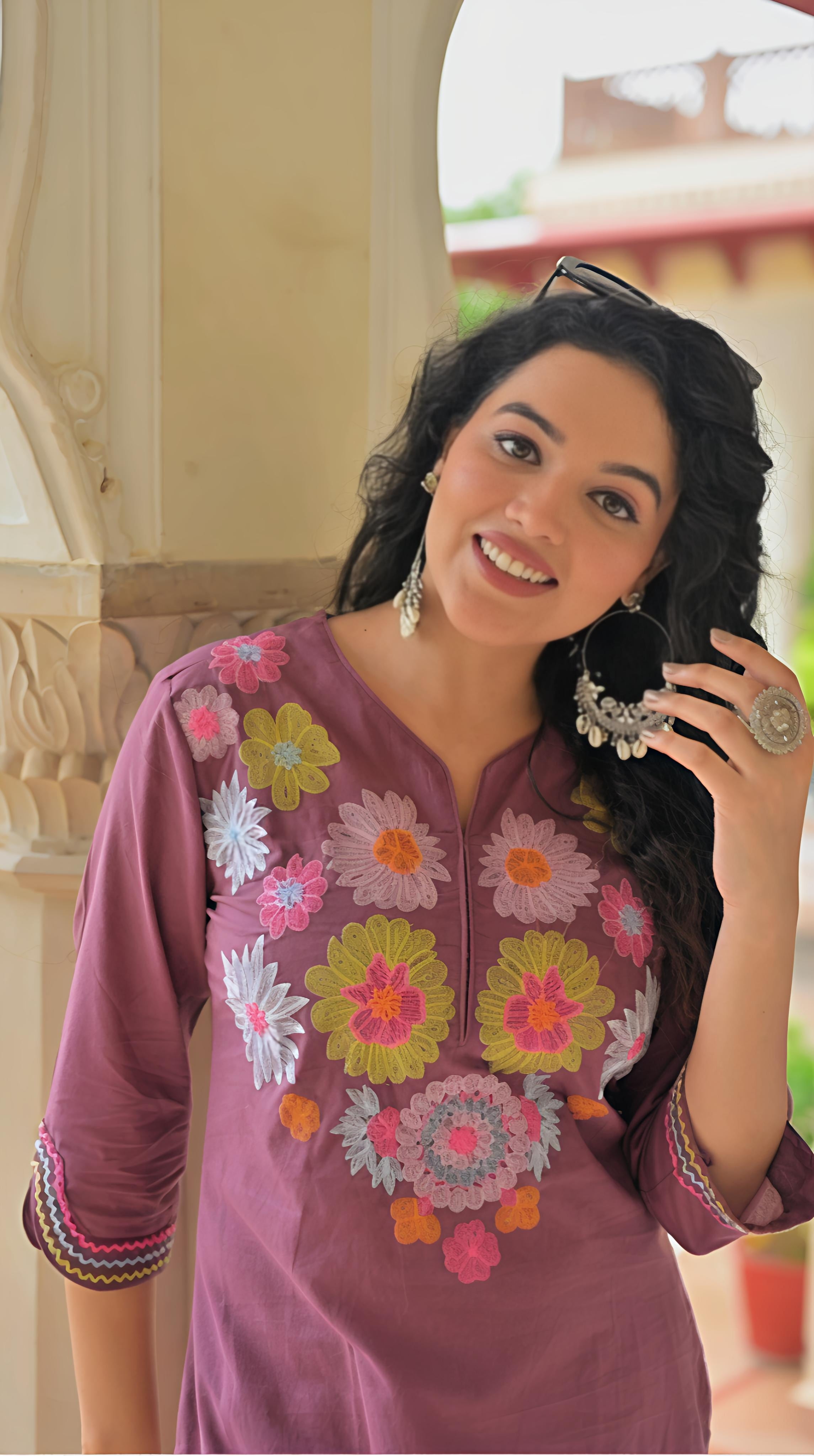Stylish traditional Indian kurta set in purple with vibrant floral embroidery and 3/4 sleeves
