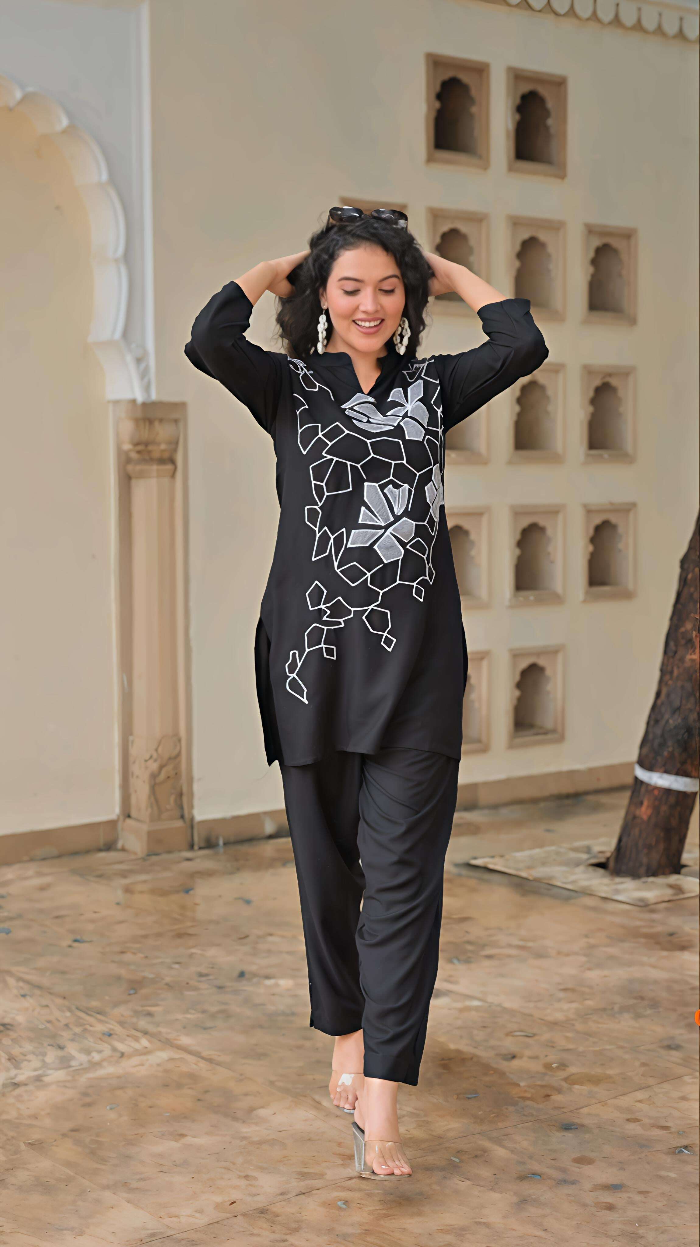 Elegant women's embroidered kurta set in black with intricate silver designs and comfortable pants
