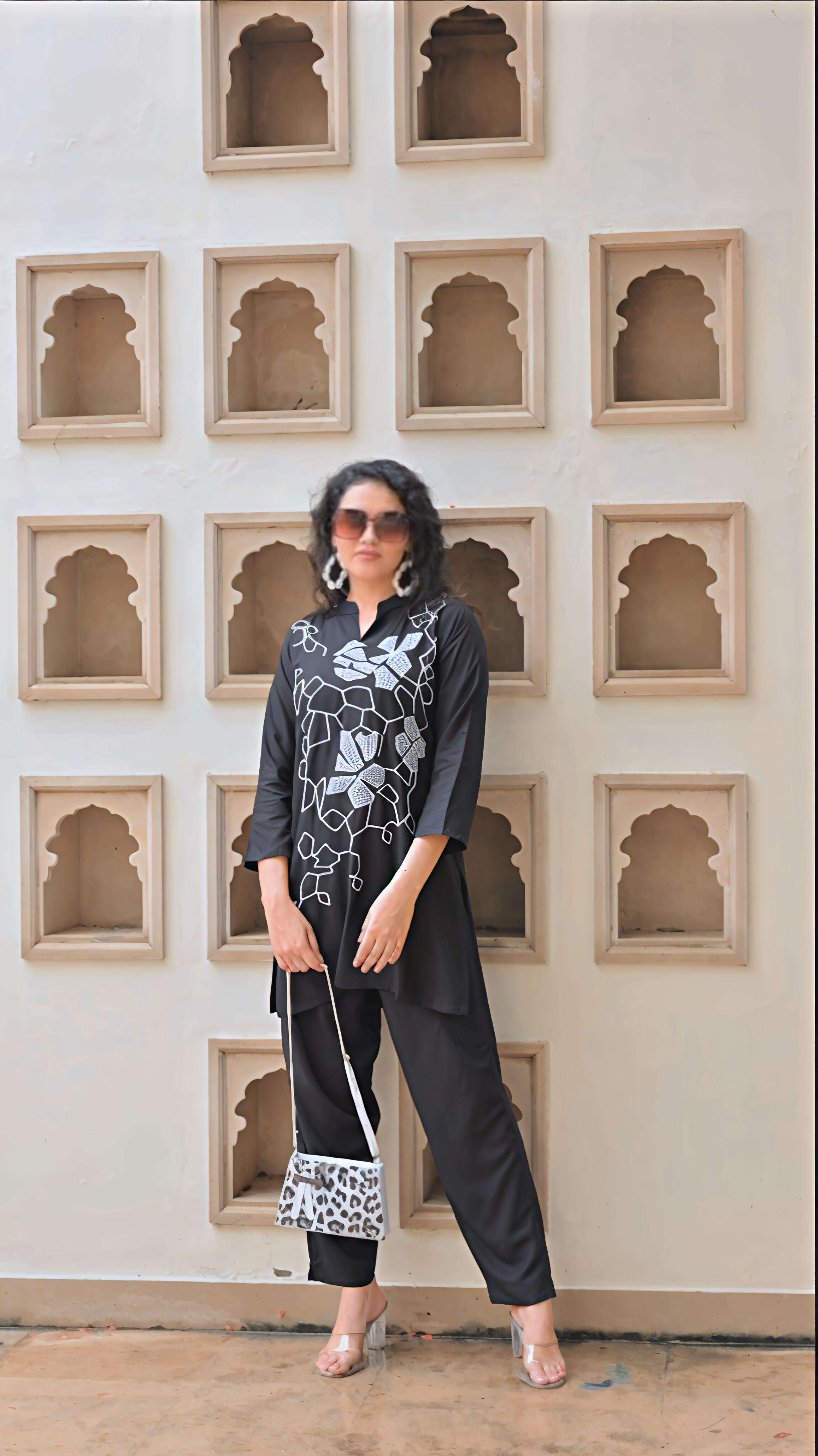 Elegant Belveera women's embroidered kurta set in black with stylish floral designs and comfortable trousers