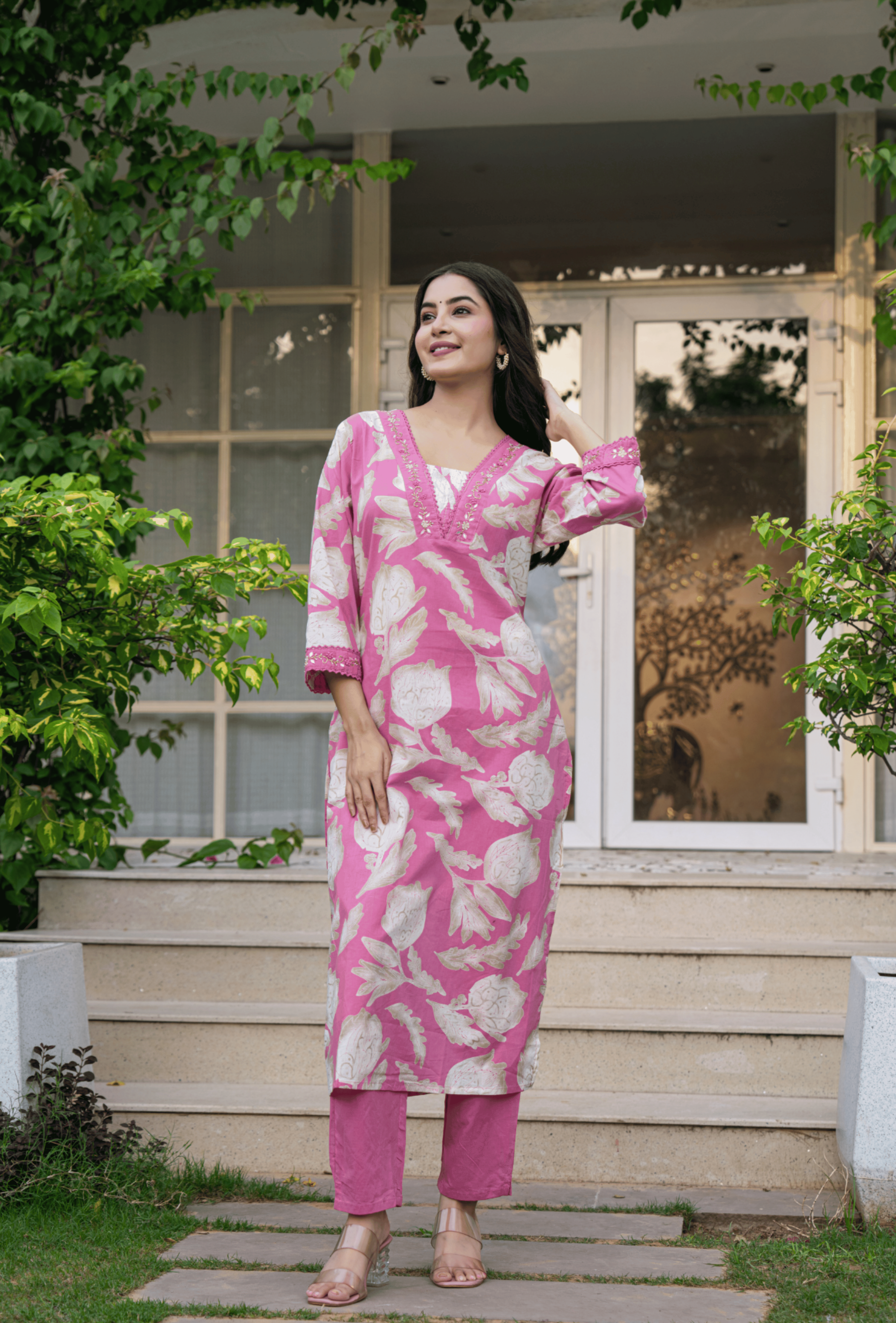 Stylish women's traditional cotton suit in pink with floral patterns perfect for casual outings