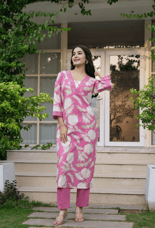 Stylish women's traditional cotton suit in pink with floral patterns perfect for casual outings