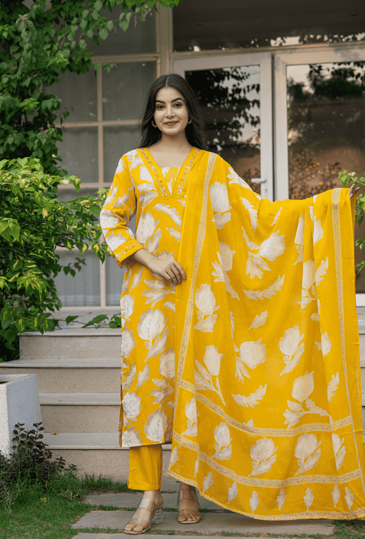 Yellow Indian cotton suit online with floral patterns and a matching dupatta for a stylish ethnic look