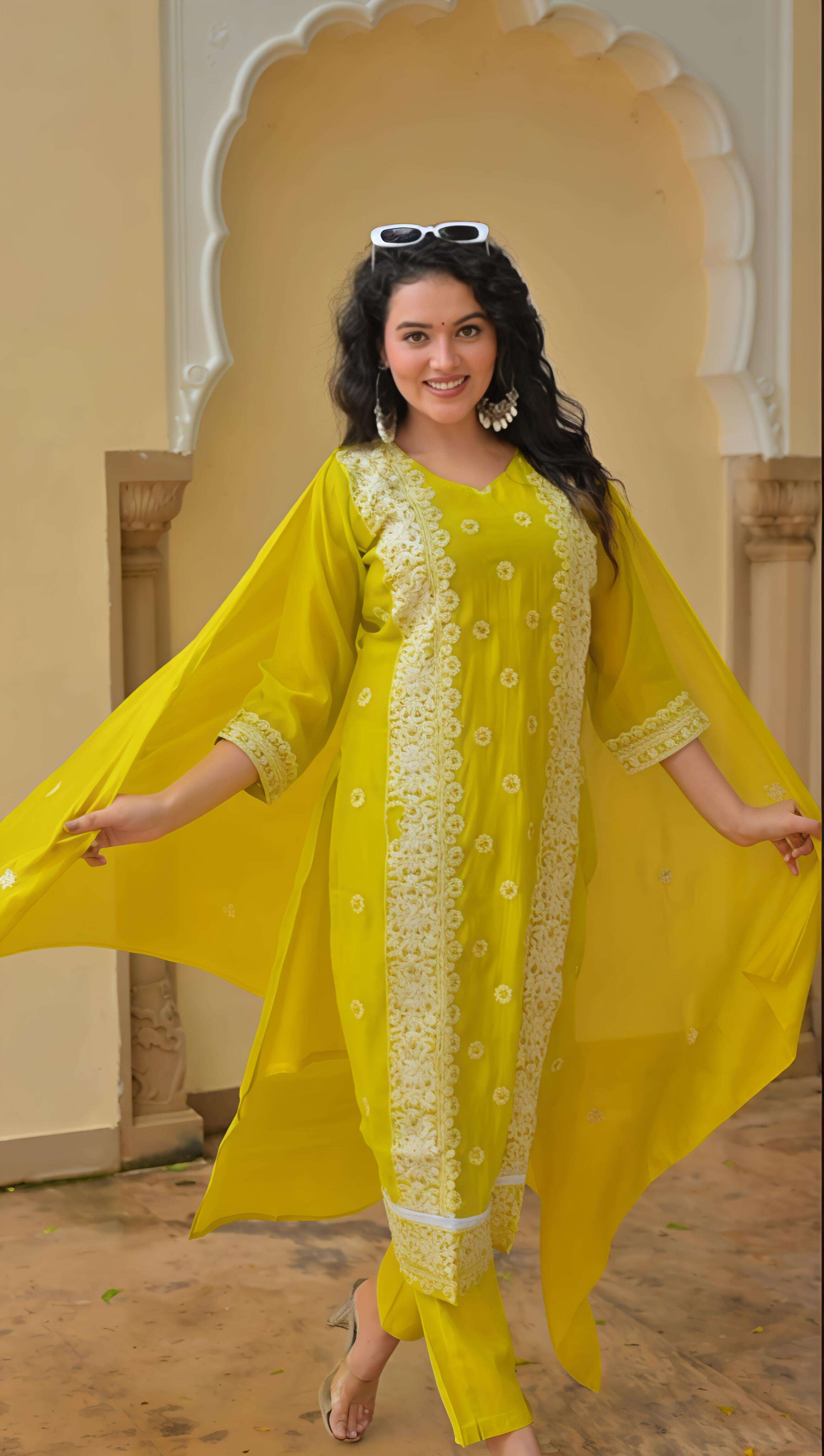 Women wearing a vibrant yellow kurta set for festive occasions with elegant embroidery and flowy design